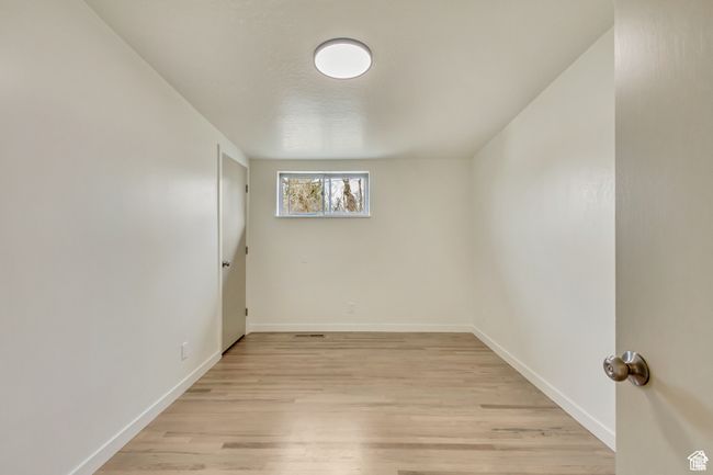 Unfurnished room featuring baseboards and light wood-style floors | Image 18