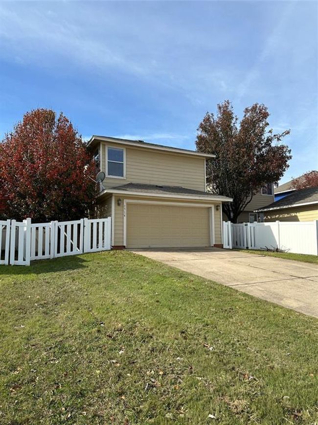 Traditional home with concrete driveway and a garage | Image 13