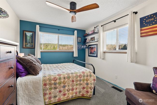 The second bedroom on the main floor offers comfort and convenience, with easy access to the nearby full bath. This thoughtful design adds functionality for everyone | Image 18
