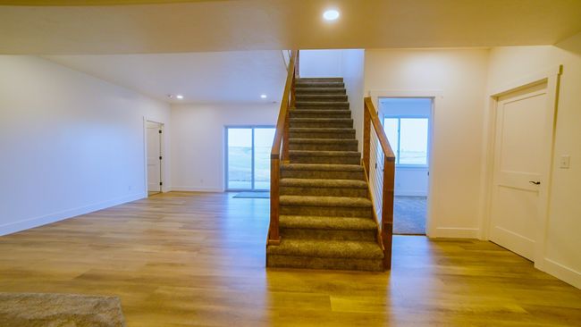 Staircase with wood finished floors and recessed lighting | Image 40