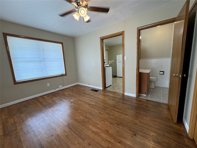 Unit A bedroom with view of bathroom and kitchen | Image 18