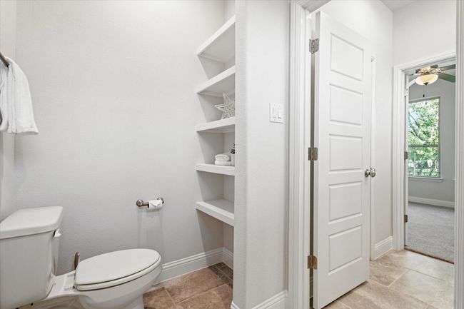 Bathroom featuring toilet and baseboards | Image 25
