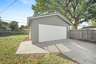 Garage featuring a lawn | Image 2