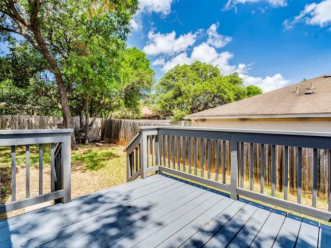 Wooden terrace with a fenced backyard | Image 26