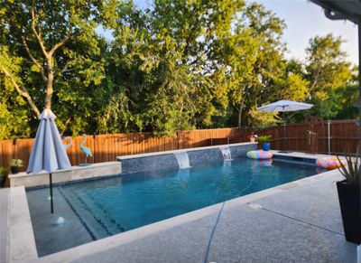 View of pool with pool water feature and a patio | Image 1