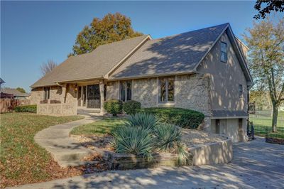 Back of house with a lawn and a garage | Image 2