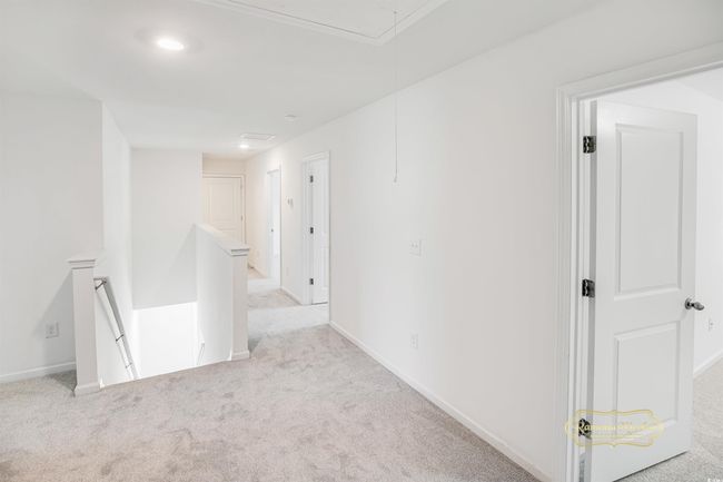 Empty room with attic access, carpet, baseboards, and recessed lighting | Image 25
