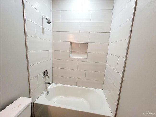 Full bathroom featuring toilet and bathtub / shower combination | Image 13