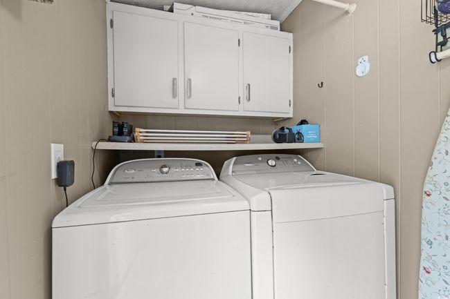 Laundry area featuring separate washer and dryer and cabinet space | Image 19