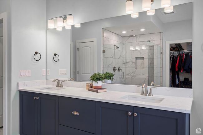 Primary full bathroom featuring a stall shower, double vanity, and a walk in closet | Image 34