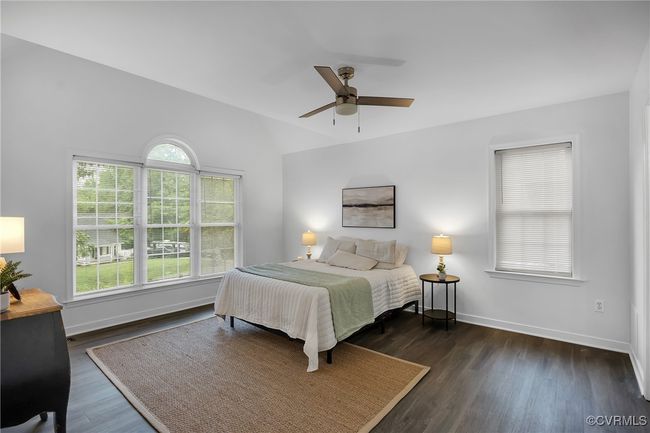 Bedroom with wood finished floors, baseboards, a ceiling fan, and lofted ceiling | Image 10