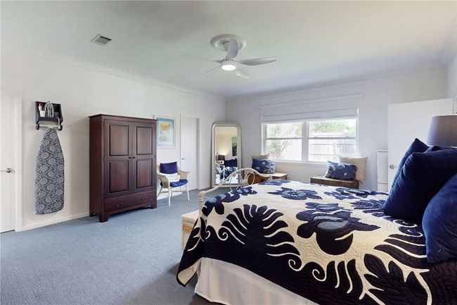 Carpeted bedroom featuring arched walkways, visible vents, crown molding, and a ceiling fan | Image 16