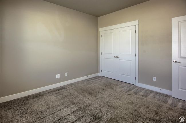 Unfurnished bedroom with carpet floors and baseboards | Image 19