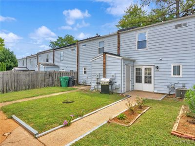 Back of property with central air condition unit and a lawn | Image 3