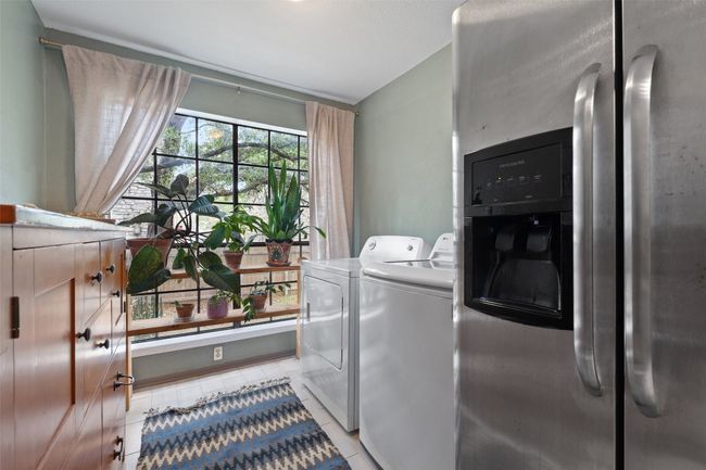 Washroom with washer and dryer and light tile patterned floors | Image 17