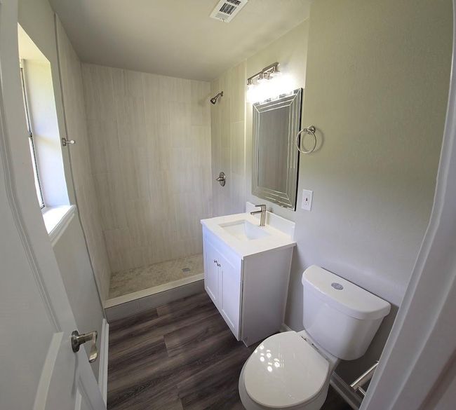 Primary bathroom with a spacious walk-in shower, sleek vanity with an undermount sink, and contemporary fixtures. The neutral color palette and good lighting create a clean, inviting atmosphere. | Image 20