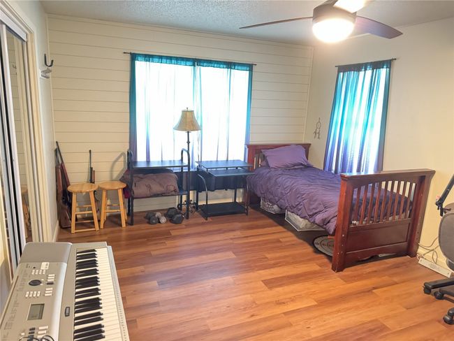 Bedroom with multiple windows, ceiling fan, and light hardwood / wood-style flooring | Image 15