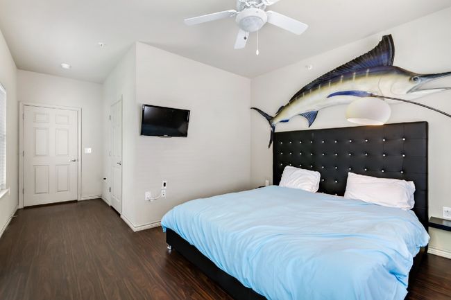 Bedroom featuring wood finished floors and a ceiling fan | Image 19