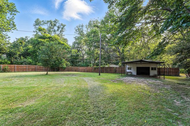 Fenced backyard with an outbuilding and a detached garage | Image 4