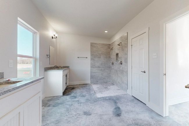 Bathroom with recessed lighting, vanity, baseboards, and a tile shower | Image 24