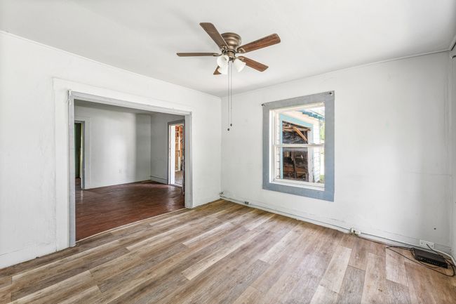 Empty room featuring light wood-style flooring and ceiling fan | Image 5