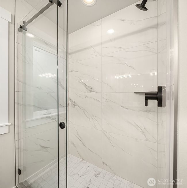 Luxurious marble-accented shower. | Image 29