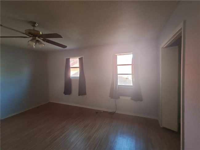 Unfurnished room with wood finished floors and ceiling fan | Image 15