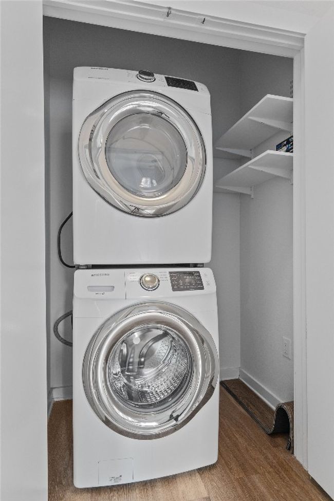 Laundry room with stacked washer and dryer | Image 21