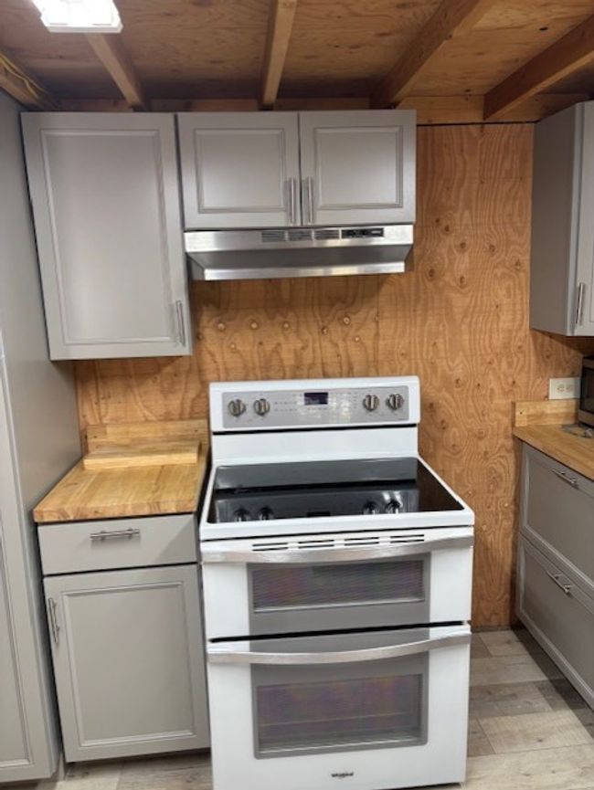 Kitchen with oven range, under cabinet range hood, gray cabinets, countertops | Image 14