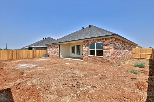Back of property with brick siding, roof with shingles, and a patio | Image 28