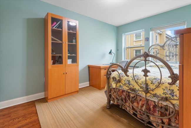 Bedroom with light wood-style floors and baseboards | Image 12