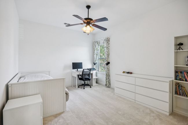 Home office with light carpet and ceiling fan | Image 20
