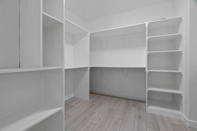 Walk in closet featuring wood finished floors | Image 29