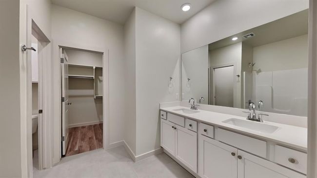 Full bathroom with walk in shower, a sink, baseboards, and visible vents | Image 12
