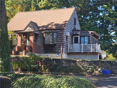 View of front facade with a wooden deck | Image 1