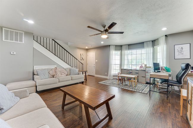Living room with visible vents, baseboards, a ceiling fan, stairway, and recessed lighting | Image 6