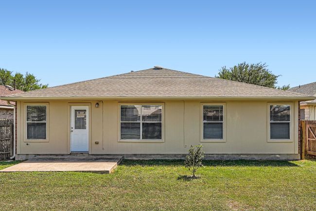 Rear view of property with a lawn, a patio area, roof with shingles, and fence | Image 26