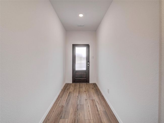 Entryway with light wood-style floors and baseboards | Image 11