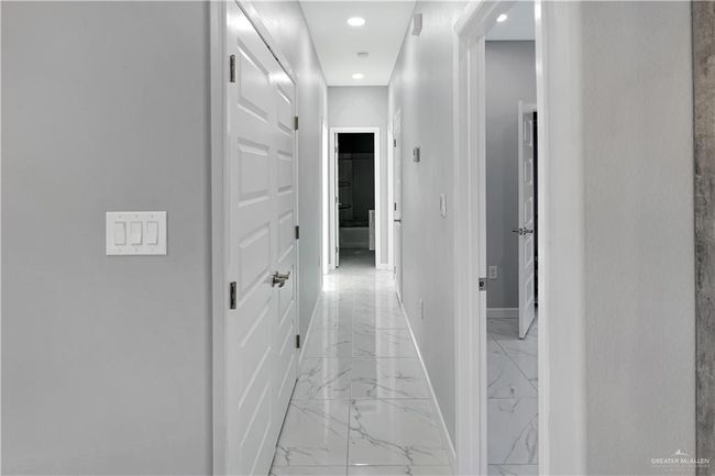 Hall with baseboards, marble finish floor, and recessed lighting | Image 8