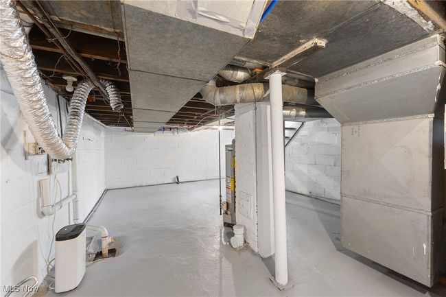 Unfinished basement with gas water heater | Image 18