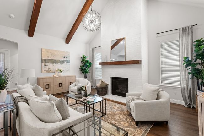 Enter the show-stopping family room. All eyes on the vaulted beam ceilings, beautiful painted brick fireplace, and tall ceilings. | Image 8