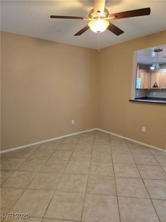 Spare room featuring baseboards, ceiling fan, and light tile patterned flooring | Image 10