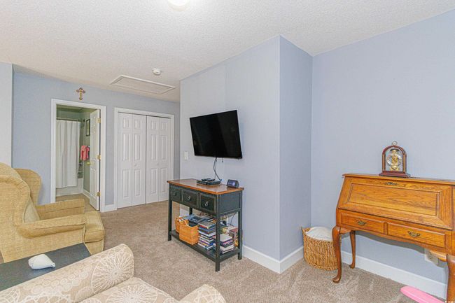 Living room featuring light colored carpet and a textured ceiling | Image 8