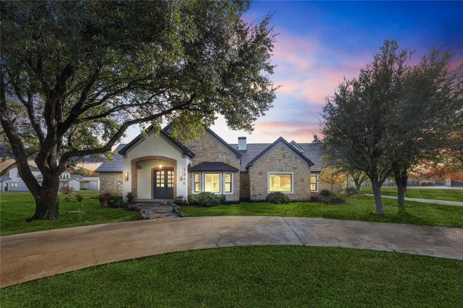 View of front facade with stone siding, a lawn, french doors, and stucco siding | Image 39