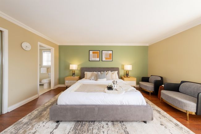 Bedroom with connected bathroom, crown molding, baseboards, and wood finished floors | Image 28