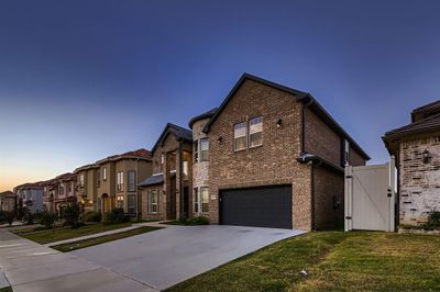 View of front of house featuring a garage and a lawn | Image 2