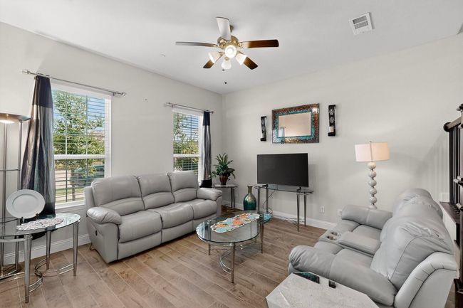 Living room featuring a ceiling fan and wood finished floors | Image 4