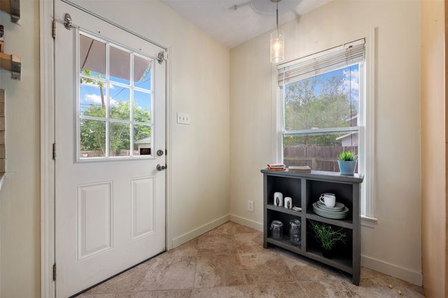 Breakfast nook in kitchen with door leading to backyard. | Image 12