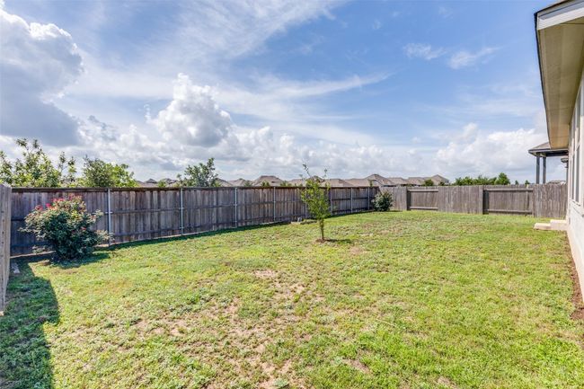 View of fenced backyard | Image 23