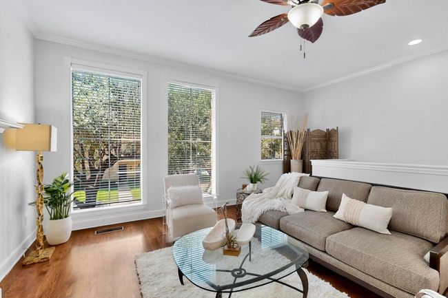Living room featuring crown molding, a ceiling fan, wood finished floors, and recessed lighting | Image 5